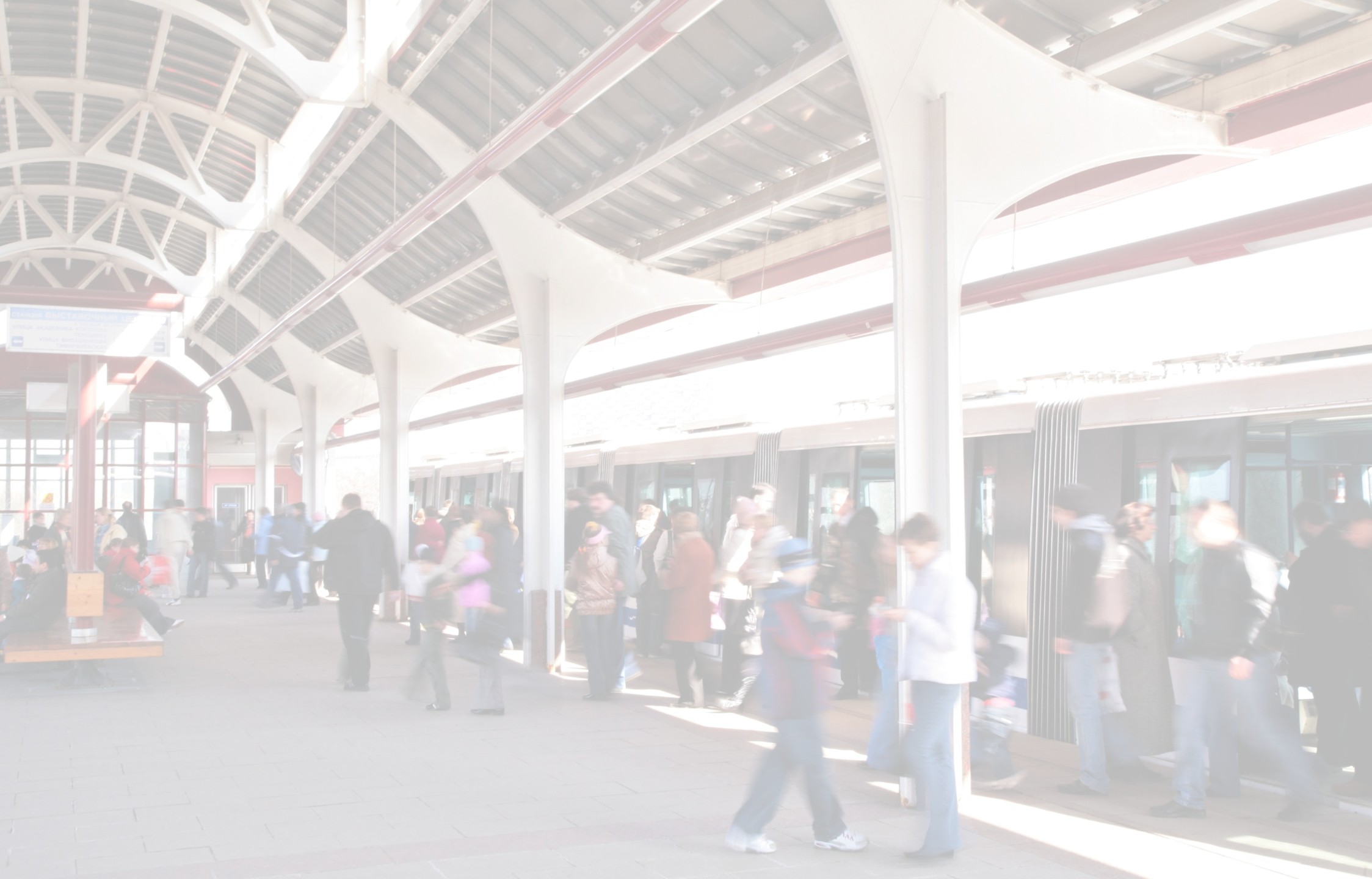 A busy train platform with passengers exiting a train.