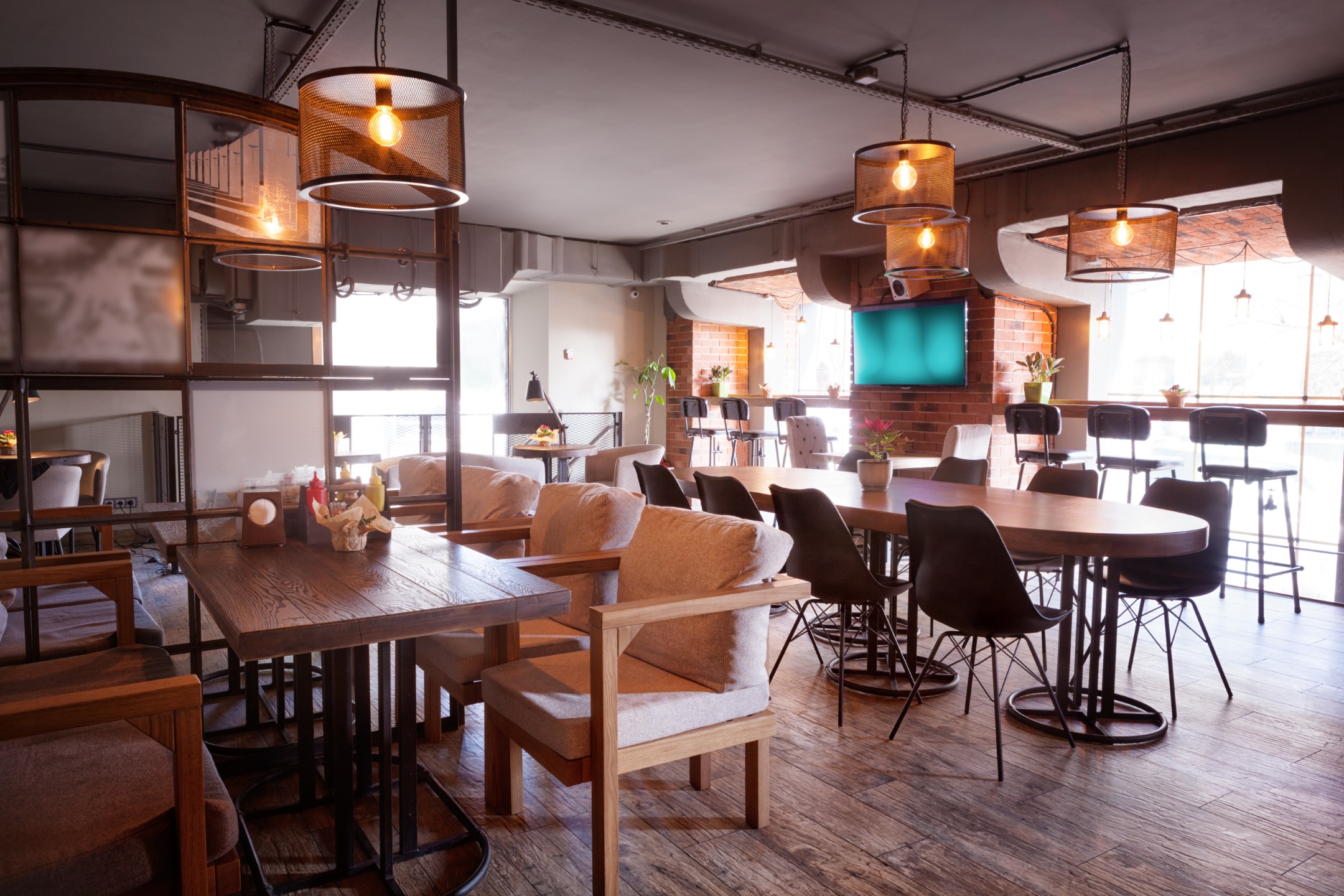 The interior of a modern cafe with lots of comfortable seating.