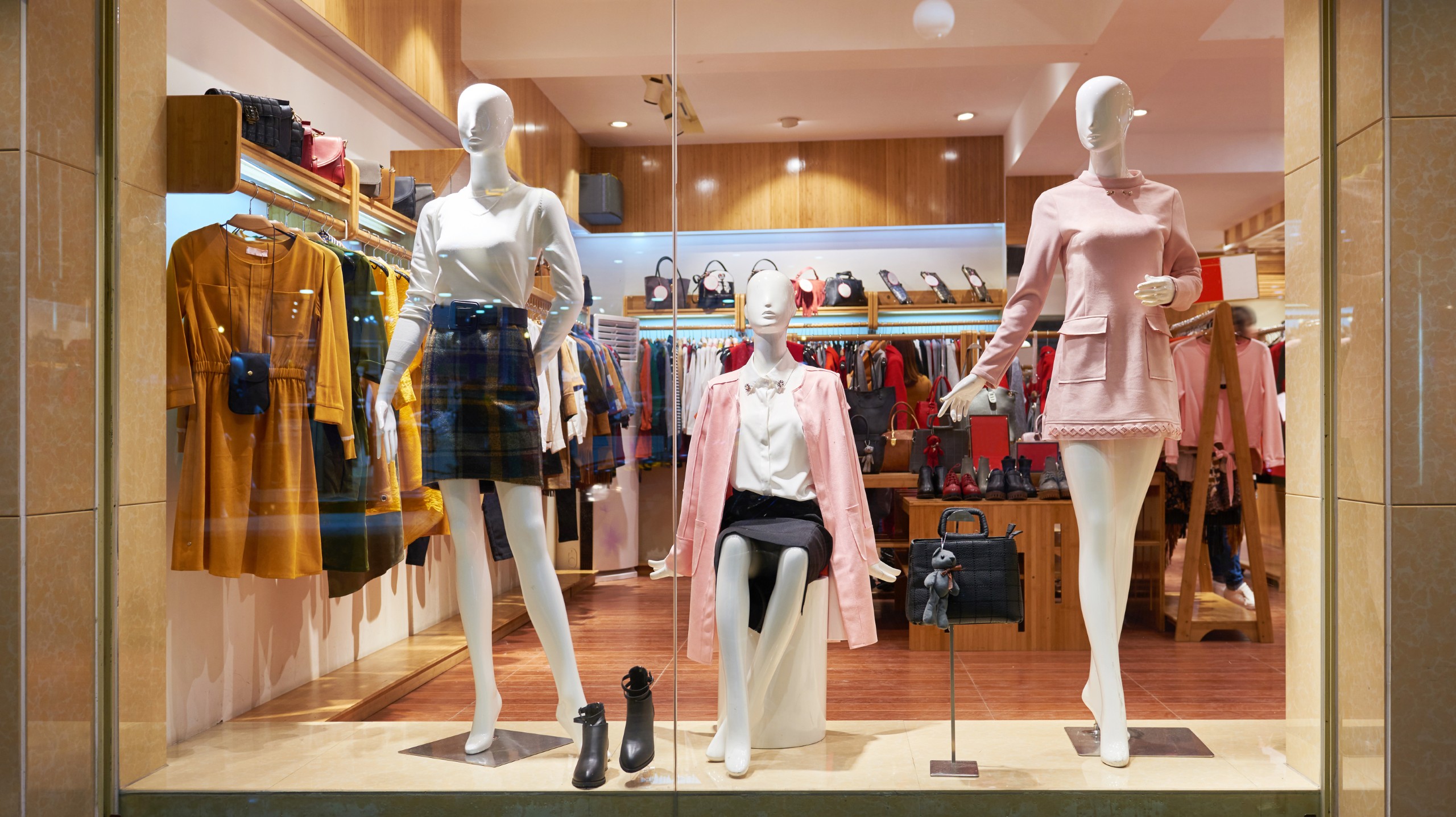 A storefront window of a women's clothing retailer at night.